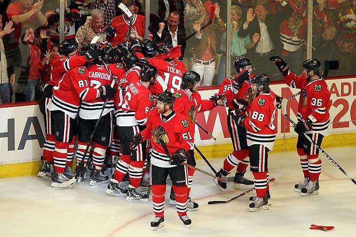 CHICAGO - MAY 21: Dustin Byfuglien #33 of the Chicago Blackhawks reacts with teammates after scoring the game-winning goal in overtime to defeat the San Jose Sharks 3-2 in Game Three of the Western Conference Finals during the 2010 NHL Stanley Cup Playoffs at the United Center on May 21, 2010 in Chicago, Illinois.   Jamie Squire/Getty Images/AFP== FOR NEWSPAPERS, INTERNET, TELCOS & TELEVISION USE ONLY ==