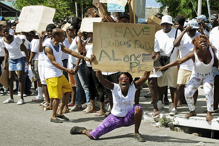 In this photo taken Thursday, May 20, 2010 a demonstrator displays a cardboard with a message in support of Christopher 