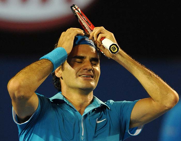 Swiss tennis player Roger Federer celebrates after victory in his men's singles final match against British opponent Andy Murray  at the Australian Open tennis tournament in Melbourne on January 31, 2010.  Federer won 6-3. 6-4. 7-6.  AFP PHOTO/Greg WOOD