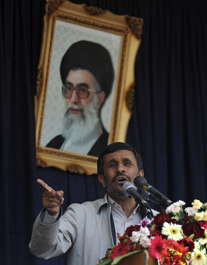 In front of a portrait of the Iranian supreme leader Ayatollah Ali Khamenei, President Mahmoud Ahmadinejad gestures while speaking during a public gathering in his provincial tour at the city of Shahr-e-Kord, 325 miles (543 kilometers)south of the capital Tehran, Iran Wednesday June 16, 2010. Iran's president says Tehran supports a dialogue with the outside world but that world powers must first be punished for the latest round of U.N. sanctions imposed on Iran. (AP Photo/IIPA, Sajjad Safari)