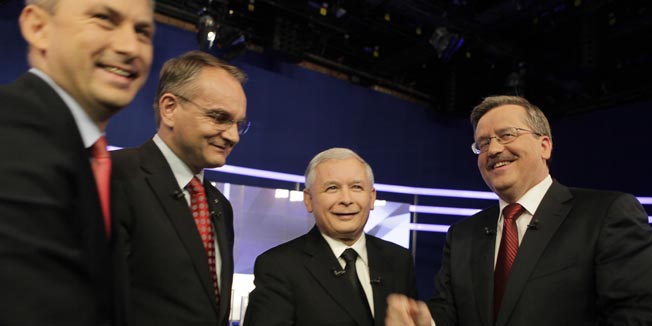 Presidential candidates, from left, Grzegorz Napieralski from the Democratic Left Alliance, Waldemar Pawlak from the Polish Peasant Party, Jaroslaw Kaczynski from the Law and Justice party and Bronislaw Komorowski, Parliament Speaker and acting president, shake hands together after a joint debate in the Polish TV, in Warsaw, Poland, Sunday, June 13, 2010. Early presidential elections will take place in Poland on June 20, with Kaczynski, twin brother of the late President Lech Kaczynki killed in a plane crash, and Komorowski the main contenders. (AP Photo/Czarek Sokolowski)