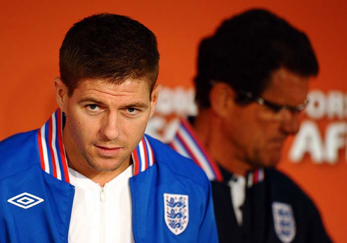 England's midfielder Steven Gerrard (L) and coach Fabio Capello arrive for a press conference in Bloemfontein on June 26, 2010, a day ahead of their round of 16 match against Germany on June 27 at the 2010 World Cup football tournament.    AFP PHOTO / PAUL ELLIS