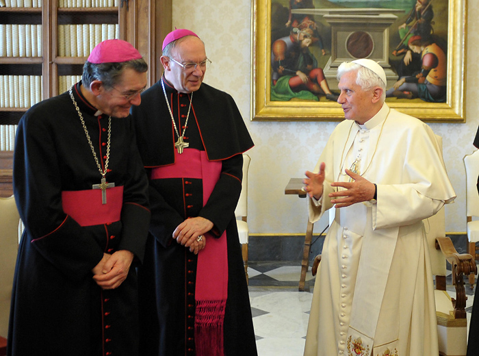 In this photo released by Vatican newspaper Osservatore Romano, Pope Benedict XVI talks with Liege Bishop Aloysius Jousten, left, and Brussels Archbishop Andre Leonard, center, during a meeting with bishops from Belgium, where the church has been rocked by recent allegations of abuse by priests and clumsy, slow handling of the cases by the bishops, at the Vatican, Saturday, May 8, 2010. Also, on Saturday, the Vatican announced that Pope Benedict accepted the resignation of Augsburg Bishop Walter Mixa, a leading figure from his German homeland, who is accused of abusing children and possible financial misconduct at a children's home.  (AP Photo/Osservatore Romano) EDITORIAL USE ONLY