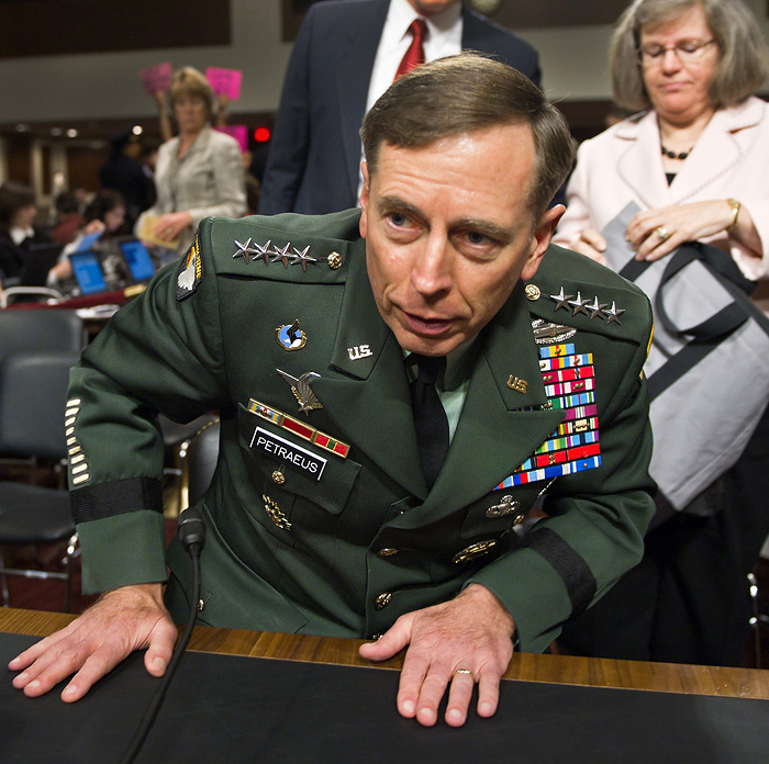 US Gen David Petraeus steps away from his table after appearing before the US Senate Armed Services Committee during his confirmation hearing to become the head of US and NATO forces in Afghanistan on Capitol Hill June 29, 2010. The hearing comes just a day after US General Stanley McChrystal, who was promptly removed from the post last week after scathing remarks he and his aids made to a magazine about top Obama administration officials, told the US Army he would retire. Petraeus's wife Holly is in the background at right.    AFP PHOTO / Paul J. Richards