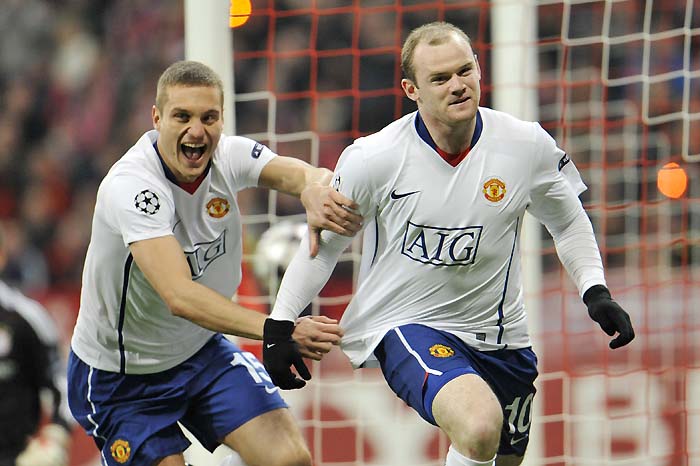Manchester's Wayne Rooney, right, and Nemanja Vidic celebrate scoring the opening goal during the Champions League quarterfinal first leg soccer match  between FC Bayern Munich and Manchester United  in Munich, southern Germany, Tuesday, March 30, 2010. (AP Photo/Kerstin Joensson) 