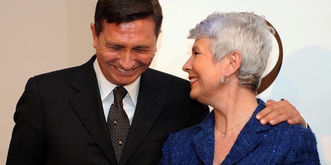 Slovenian Prime Minister Borut Pahor (L) smiles as he hugs his Croatian counterpart Jadranka Kosor in Zagreb, on March 31, 2010. Pahor arrived for an unexpected one-day unofficial visit to Zagreb to participate at the opening of the exhibition of Slovenian artist Oskar Kogoj and Croatian artist Nenad Fabijanic (both out of camera range).  AFP PHOTO/ HRVOJE POLAN