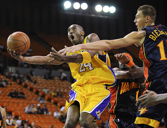 Los Angeles Lakers guard Kobe Bryant (24) drives to the basket past Golden State Warriors center Andris Biedrins in the first half of a preseason NBA basketball game, Friday, Oct. 9, 2009, in Inglewood, Calif. (AP Photo/Gus Ruelas)