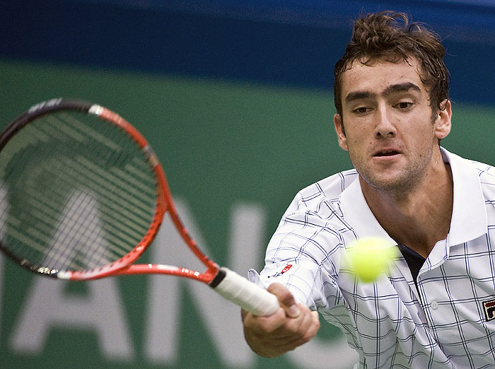 Croatia's Marin Cilic returns a ball against Tomas Berdych of the Czech Republic at the Shanghai ATP Masters 1000 tennis tournament in Shanghai, China, Tuesday, Oct. 13, 2009. (AP Photo/Andy Wong)