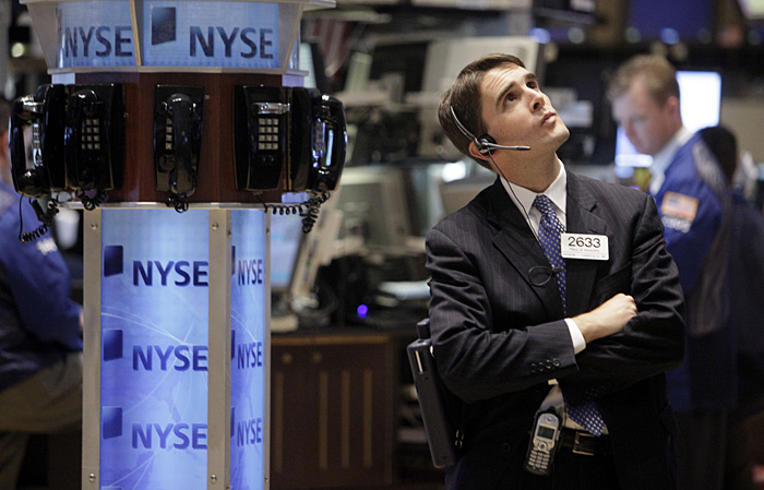 Trader Paul Maguire works on the floor of the New York Stock Exchange Monday, Oct. 19, 2009. The stock market stepped to new highs for the year Monday after a handful of earnings reports bolstered hopes that the economy is coming back sooner than many analysts had thought. (AP Photo/Richard Drew)