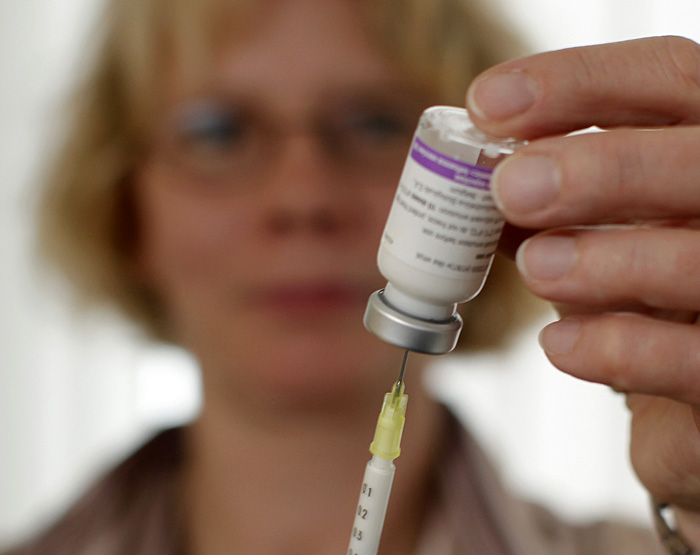 FILE - In this Tuesday, Nov. 3, 2009 file photo, a nurse prepares an injection with the vaccine Pandemrix in Bremen, Germany. In Germany, doctors have also been contacting high-priority patients to come in for their swine flu shot, though other people who have asked for one have not been turned away. (AP Photo/Joerg Sarbach)