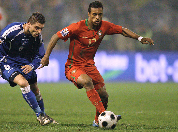 Bosnia-Herzegovina's Damjanovic, left, goes for the ball with Portugal's Nani during their World Cup qualifying playoff second leg soccer match Wednesday, Nov. 18, 2009, at the Bilino Polje  stadium in Zenica, Bosnia. (AP Photo/Armando Franca)