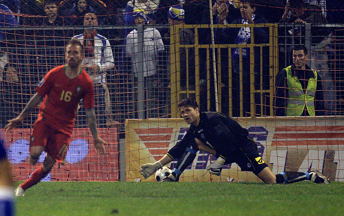 Bosnia-Herzegovina's goalkeeper Kenan Hasagic, right, reacts after Portugal's Raul Meireles , left, scored the opening goal during their World Cup qualifying playoff second leg soccer match Wednesday, Nov. 18, 2009, at the Bilino Polje stadium in Zenica, Bosnia. (AP Photo/Armando Franca)