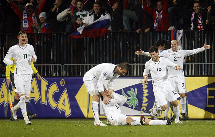 Slovenia's players celebrate their goal against Russia during their World Cup qualifying playoff second leg soccer match  in Maribor, Slovenia, Wednesday, Nov. 18, 2009. (AP Photo/Darko Bandic)