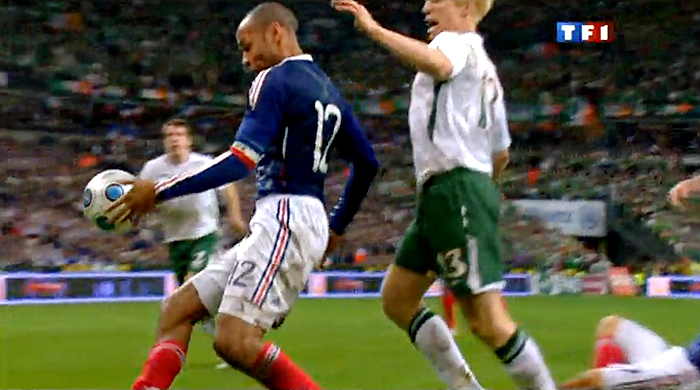 TV grab shows French forward Thierry Henry (L) eyes the ball next to Irish Paul Mc Shane during the World Cup 2010 qualifying football match France vs. Republic of Ireland on November 18, 2009 at the Stade de France in Saint-Denis, northern Paris. Superstar Thierry Henry was at the centre of a sensational cheating storm as France reached the World Cup finals along with Portugal, Greece and Slovenia.  France, the 1998 champions and 2006 runners-up, drew 1-1 with Ireland at the Stade de France in the second leg of their play-off for a 2-1 aggregate win. But the extra-time triumph came in controversial circumstances when French skipper Henry appeared to control the ball with his hand before his angled pass allowed William Gallas to head in the crucial 103rd-minute goal.       AFP PHOTO GRAB / TF1 / 