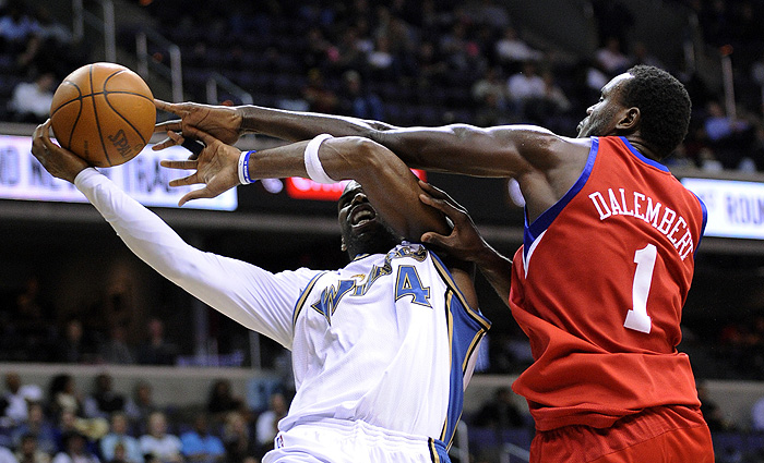 Philadelphia 76ers center Samuel Dalembert (1) fouls Washington Wizards forward Antawn Jamison (4) during the second half of an NBA basketball game Tuesday, Nov. 24, 2009, in Washington. The Wizards won 108-107. (AP Photo/Nick Wass)