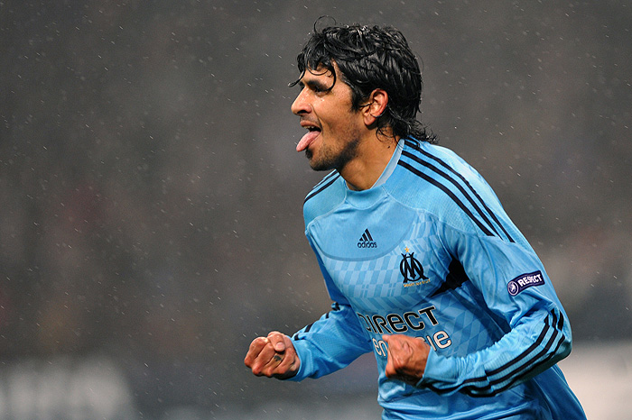 Olympique Marseille's Argentinian midfielder Lucho Gonzalez celebrates after scoring against A.C Milan during their UEFA Champions League group stage football match on November 25, 2009 at San Siro stadium in Milan.  AFP PHOTO / Giuseppe Cacace