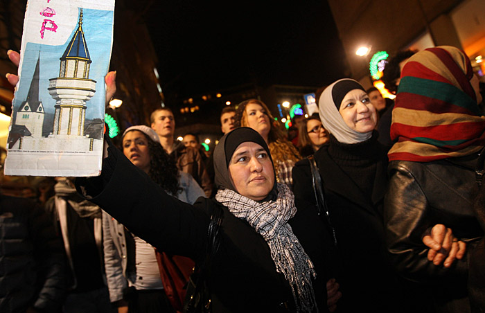 Demonstrators protest against the results of a vote that banned new minarets, in Lausanne, Switzerland, Tuesday, Dec. 1, 2009. Swiss voters have approved  Sunday a right-wing-backed proposal to ban construction of new minarets, a surprise result that could damage Switzerland's economic ties with Muslim states. (AP Photo/Keystone/Jean-Luc Barmaverain)