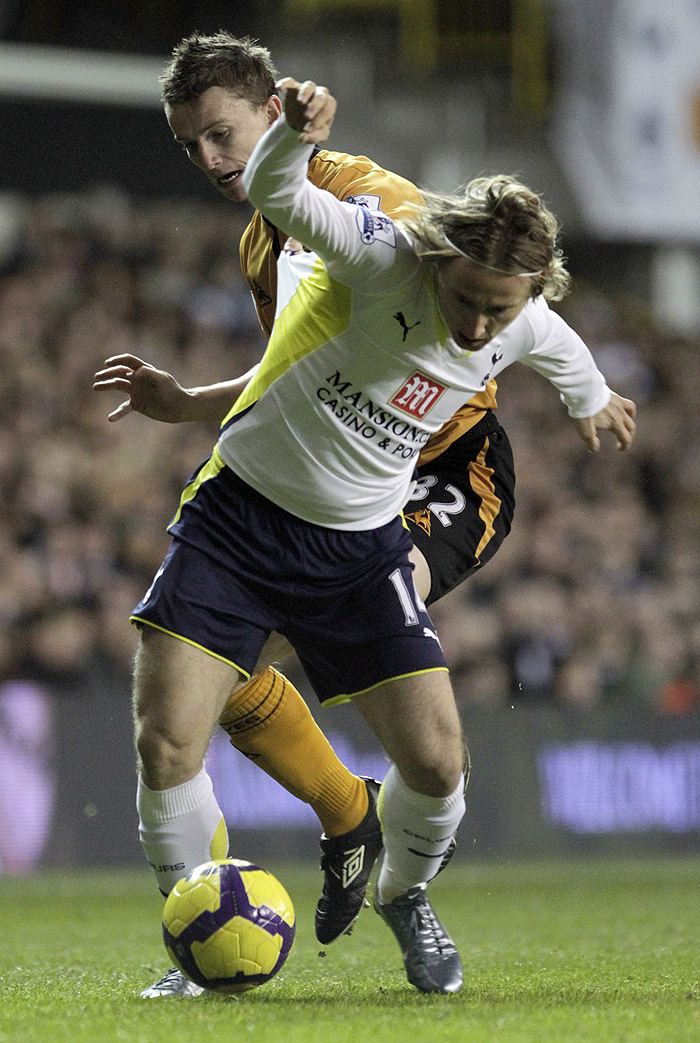 Tottenham Hotspur's Luka Modric, front, vies for the ball with Wolverhampton Wanderers' Kevin Foley during their English Premier League soccer match at White Hart Lane stadium, London, Saturday, Dec. 12, 2009. (AP Photo/David Azia) ** NO INTERNET/MOBILE USAGE WITHOUT FOOTBALL ASSOCIATION PREMIER LEAGUE (FAPL) LICENCE. CALL +44 (0) 20 7864 9121 or EMAIL info@football-dataco.com FOR DETAILS **