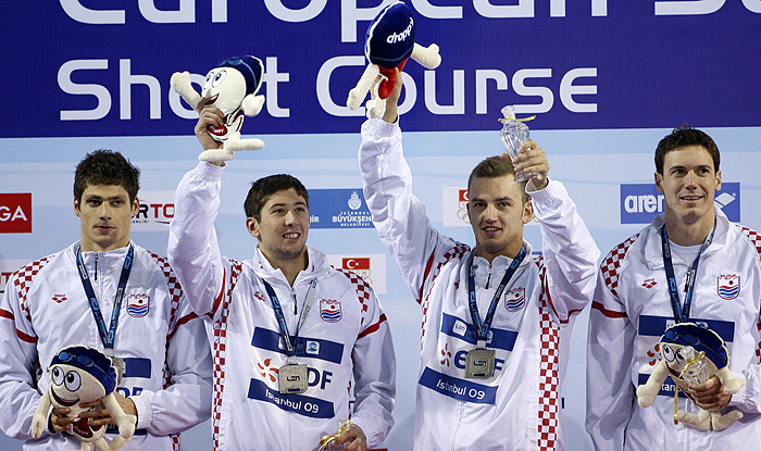 Croatia's relay team members Mario Delac, Mario Todorovic, Alexei Puninski and Duje Draganja (L-R) pose with their silver medals during the medal ceremony for the men's 4x50m freestyle final at the European Short Course Swimming Championships in Istanbul December 13, 2009. REUTERS/Murad Sezer (TURKEY - Tags: SPORT SWIMMING)