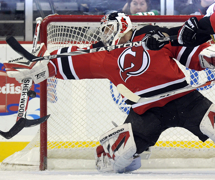 New Jersey Devils goalie Martin Brodeur deflects a shot from the Ottawa Senators in the second period of their NHL hockey game in Newark, New Jersey, December 18, 2009. Brodeur set the NHL record for career appearances by a goalie when he started the game.  REUTERS/Ray Stubblebine  (UNITED STATES - Tags: SPORT ICE HOCKEY)