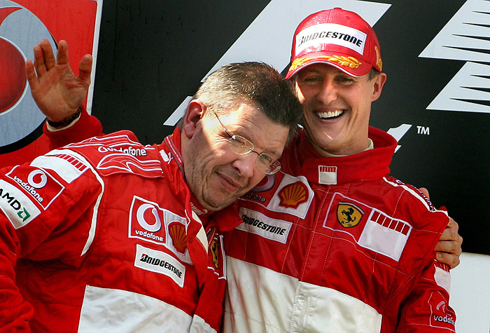 Ferrari F1 driver Michael Schumacher celebrates on the podium with technical director Ross Brawn (L) after winning the European Formula One Grand Prix at Nuerburgring racing circuit in western Germany in this May 7, 2006 file photo. Schumacher will come out of retirement to make a Formula One comeback with Mercedes next year at the age of 41, the team said on December 23, 2009. Picture taken May 7, 2006. REUTERS/Christian Charisius/Files (GERMANY - Tags: SPORT MOTOR RACING IMAGES OF THE DAY)