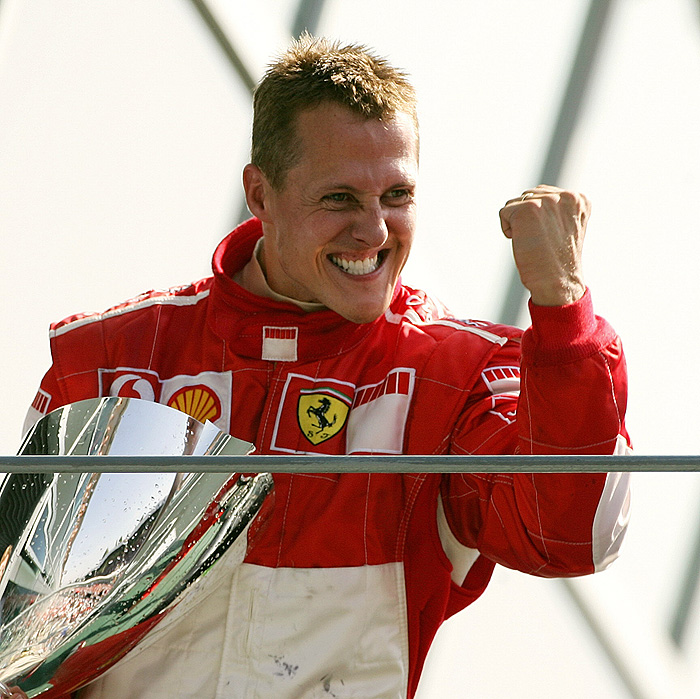 (FILES) - Picture taken on September 10, 2006 shows then German Ferrari driver Michael Schumacher celebrating on the podium of the Monza racetrack after the Italian Formula One Grand prix, in Monza. Michael Schumacher has signed a one-year deal to return to Formula One racing with Mercedes GP for the 2010 season, Bild.de reported on December 22, 2009. AFP PHOTO  PATRICK HERTZOG