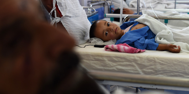 (FILES) In this photograph taken on May 21, 2015, an Afghan child receives treatment at the Medecins Sans Frontieres (MSF), or Doctors Without Borders, hospital in the northern city of Kunduz, after being wounded in a fight between the Taliban and Afghan security forces. An air strike on the hospital in the Afghan city of Kunduz on October 3 left three Doctors Without Borders staff dead and dozens more unaccounted for, the medical charity said, with NATO conceding US forces may have been behind the attack. The MSF facility is seen as a key medical lifeline in the region and has been running 