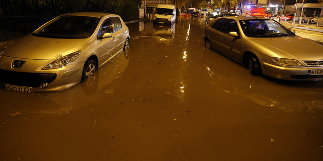Cars are seen on a flooded street on October 03, 2015 in Nice, southeastern France.  AFP PHOTO / VALERY HACHE