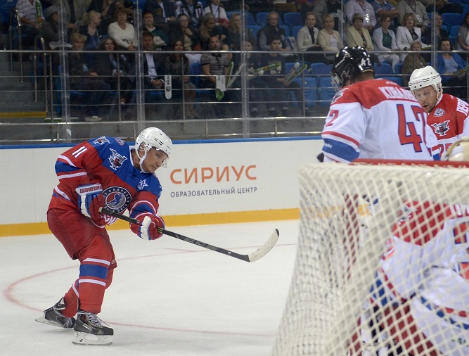 Russian President Vladimir Putin takes part in a hockey match during the opening of a new season of the Night Ice Hockey League in Sochi on October 7, 2015. AFP PHOTO / RIA NOVOSTI / ALEXEI NIKOLSKY