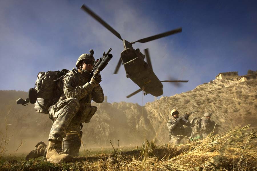 (FILES) In this photograph taken on November 20, 2008, US Army soldiers from 2-506 Infantry 101st Airborne Division and Afghan National Army soldiers take positions after racing off the back of a UH-47 Chinook helicopter during the launch of Operation Shir Pacha into the Derezda Valley in the rugged Spira mountains in Khost province, along the Afghan-Pakistan Border, directly across the border from Pakistan's lawless Waziristan region.   A helicopter from the NATO-led foreign force in Afghanistan has crashed during an anti-Taliban operation, an Afghan official said August 6, 2011, adding there were foreign troop casualties. The helicopter came down late August 5 in a Taliban-infested district of the eastern province of Wardak, southwest of Afghan capital Kabul, said provincial spokesman Shahidullah Shahid. An eyewitness told AFP that the helicopter had crashed as it was trying to take off after landing on the roof of a Taliban commander's home during a firefight. AFP PHOTO/DAVID FURST/FILES