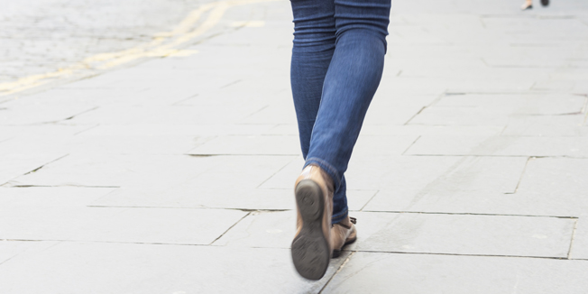 MRMR  Model released image of a woman's legs and feet as she walks down a British shopping street