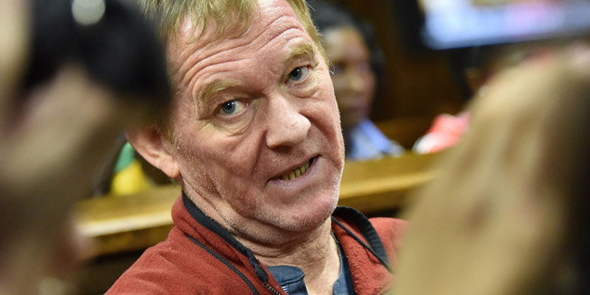 Danish man living in South Africa, Peter Frederiksen sits in the accused dock ahead of his bail application at the Bloemfontein Magistrate's court on November 4, 2015. Frederiksen was arrested in September 2015 after twenty-one severed vaginas were found stored in his home freezer. AFP PHOTO / Charl Devenish