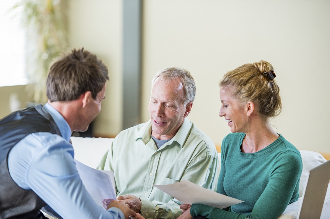 Couple talking to their financial advisor