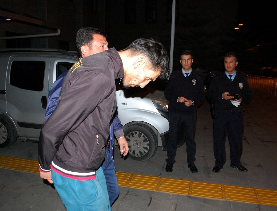 The 26-year old Belgian citizen Ahmet Dahmani is escorted by a plain clothes police officer on November 20, 2015 in Antalya. Turkish police have arrested a Belgian man of Moroccan origin on suspicion he scouted out the target sites for Islamic State in attacks that killed 129 people in Paris a week ago, a Turkish government official said on November 21, 2015. AFP PHOTO / IHLAS NEWS AGENCY / TURKEY OUT