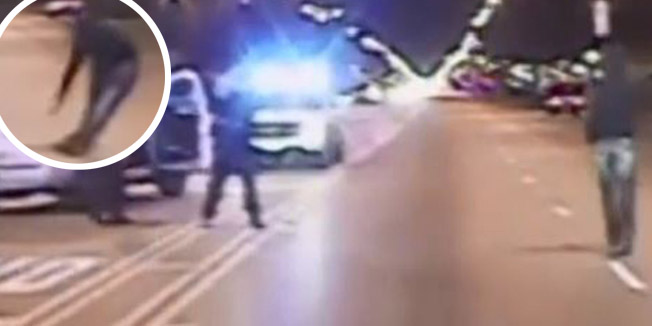 In this screen grab from a video released by the Chicago Police on November 24, 2015, Laquan McDonald (R) looks at police,  before being shot, in Chicago, Illinois on October 24, 2014. Chicago's mayor appealed for calm as officials released a 