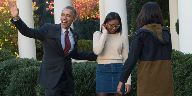 US President Barack Obama leaves with daughters Malia (R) and Sasha after 