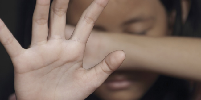 Little girl suffering bullying raises her palm asking to stop the violence