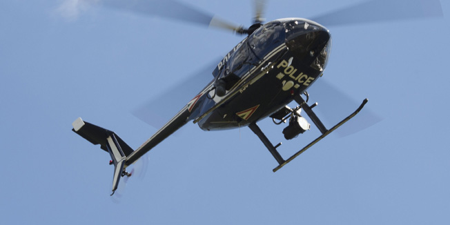 ROSZKE, HUNGARY - SEPTEMBER 09:  A hungarian police helecopter surveys an area of farmland for people attempting to evade registration on September 9, 2015 in Morahalom, Hungary. Thousands of migrants have continued to cross into Hungary over the last few days from Serbia. Since the beginning of 2015 the number of migrants using the so-called 'Balkans route' has exploded with migrants arriving in Greece from Turkey and then travelling on through Macedonia and Serbia before entering the EU via Hungary. The number of people leaving their homes in war torn countries such as Syria, marks the largest migration of people since World War II.  (Photo by Dan Kitwood/Getty Images)