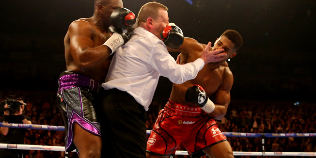 LONDON, ENGLAND - DECEMBER 12:  Anthony Joshua (R) throws a punch after the bell at the end of the first round as the referee intervenes during the British and Commonwealth heavyweight title contest against Dillian Whyte (L) at the Matchroom Boxing promotion 'Bad Intentions' at The O2 Arena on December 12, 2015 in London, England.  (Photo by Richard Heathcote/Getty Images)