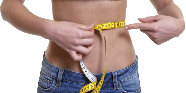 Woman with measuring tape on an isolated white background for cut out