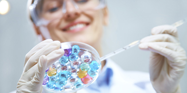 Medical or scientific researcher or doctor using looking at a solution in a laboratory 