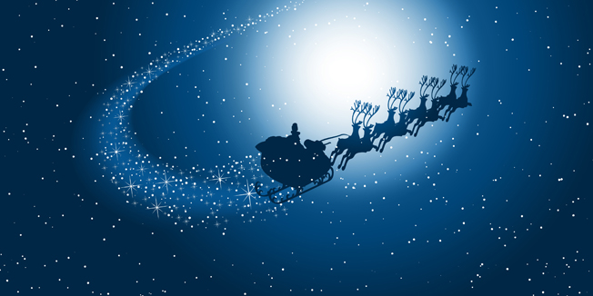 Silhouette of santa flying through the snowy night sky with starry trail
