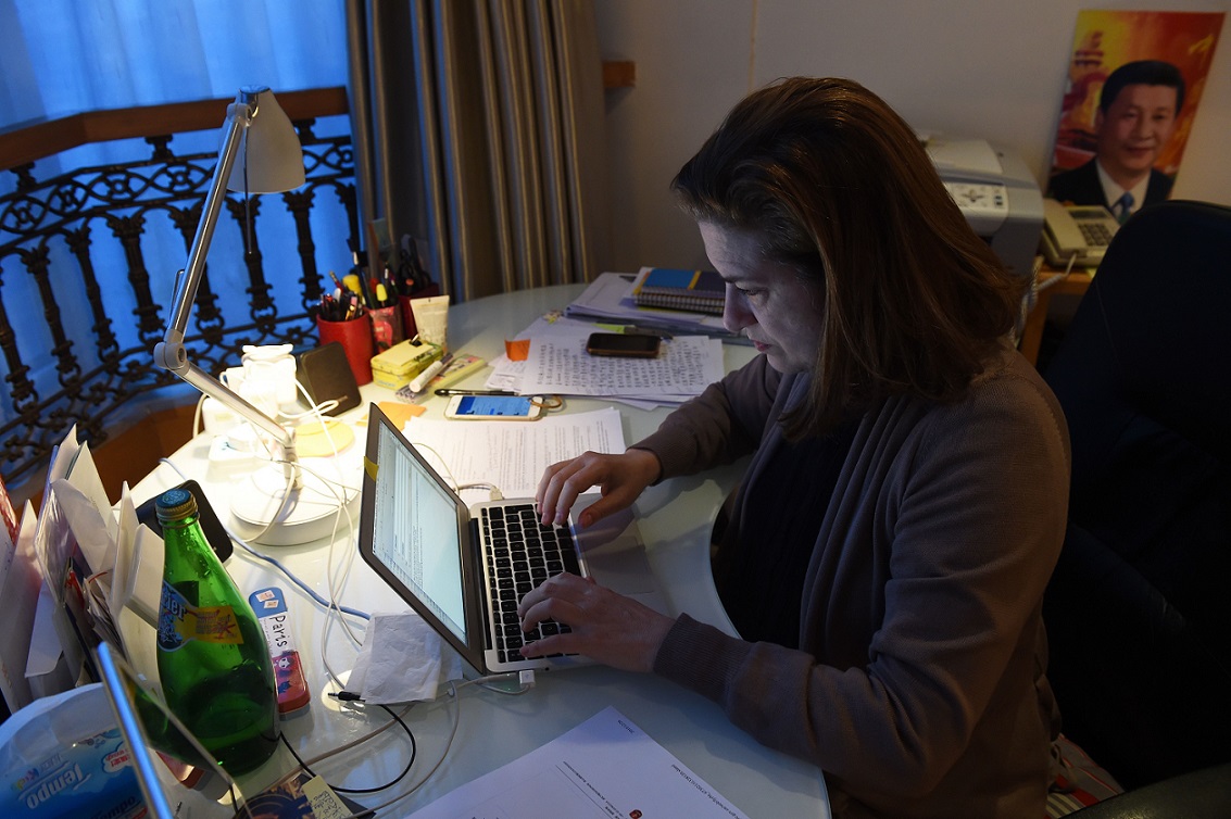 Ursula Gauthier, the Beijing-based correspondent for French news magazine L'Obs, works at her desk in her apartment in Beijing on December 26, 2015.  China confirmed the imminent expulsion of Gauthier in the first such case since 2012, accusing her of 