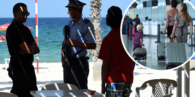 A Tunisian policeman stands guard on July 10, 2015 in the Mouradi Hotel in the touristic Port el Kantaoui, on the outskirts of Sousse south of the capital Tunis. Denmark followed Britain's example in urging its nationals to cut short their holidays in Tunisia after London warned the country was still unsafe after last month's beach massacre. AFP PHOTO / FETHI BELAID