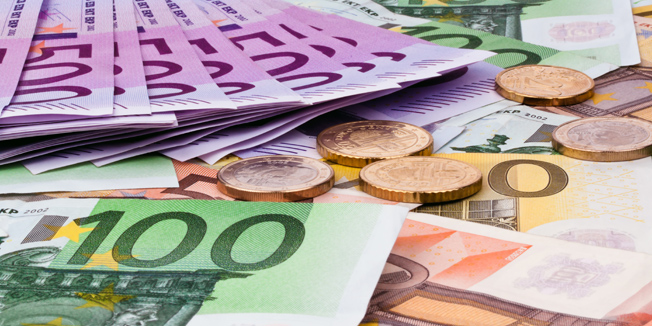 many euro banknotes of the european union. and budget savings