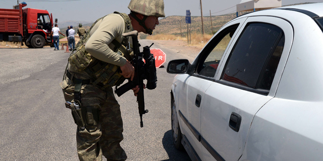 A Turkish soldier checks cars at a checkpoint in Diyarbakir on July 26, 2015 following the death of two Turkish soldiers. A car bomb attack killed two Turkish soldiers in the Kurdish-dominated southeast of the country, after separatist rebels warned they would no longer observe a truce after Ankara's air strikes on their positions in Iraq, officials said on July 26. Turkey has launched a two-pronged 