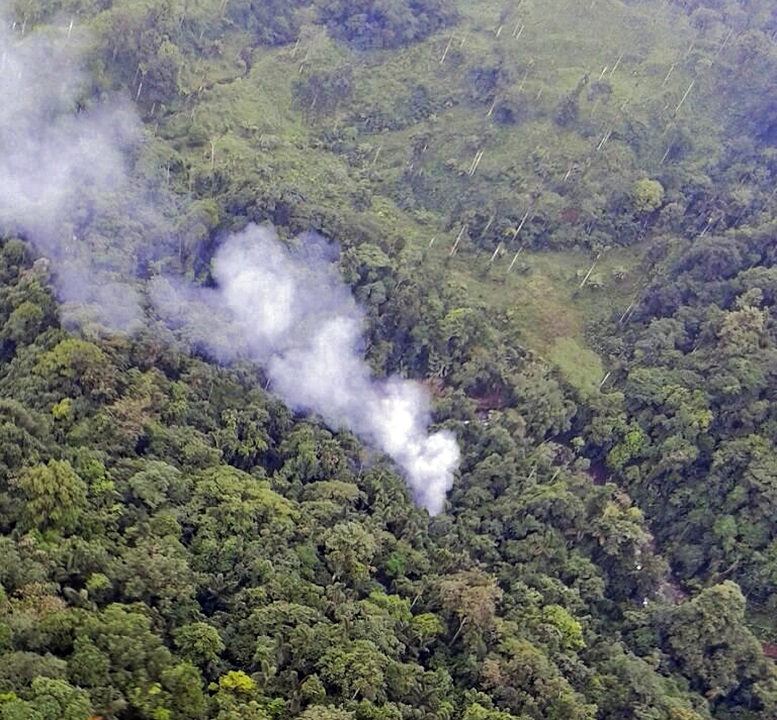 Handout picture released by the Colombian Police showing smoke billowing from the site where a Police Blackhawk helicopter went down killing 15 officers and wounding another two, during an operation part of the Agamennon offensive against drug traffickers from the 