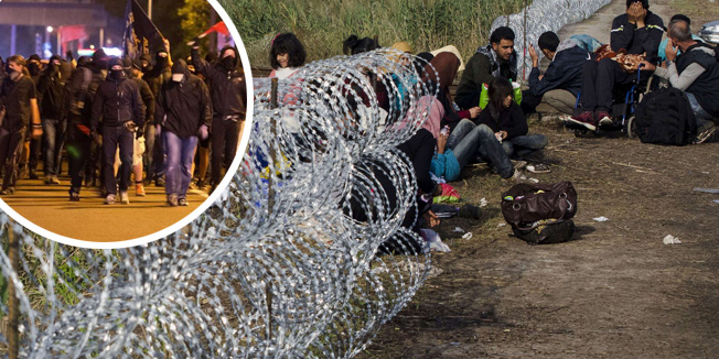 A migrant family rests beside the border fence near the border village Asotthalom, at the Hungarian-Serbian border on August 23, 2015 as the metal fence was cut by migrants. At least 2,000 more migrants flooded overnight into Serbia in a desperate journey to try and go on to Hungary, the door into the European Union, a UN official said on August 24, 2015.  AFP PHOTO / CSABA SEGESVARI
