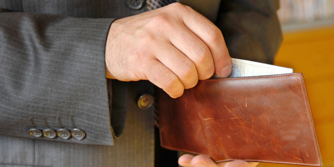 businessman hand holding a opened leather wallet