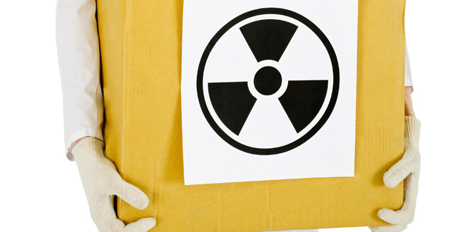 A scientist with a radioactive box isolated on white background